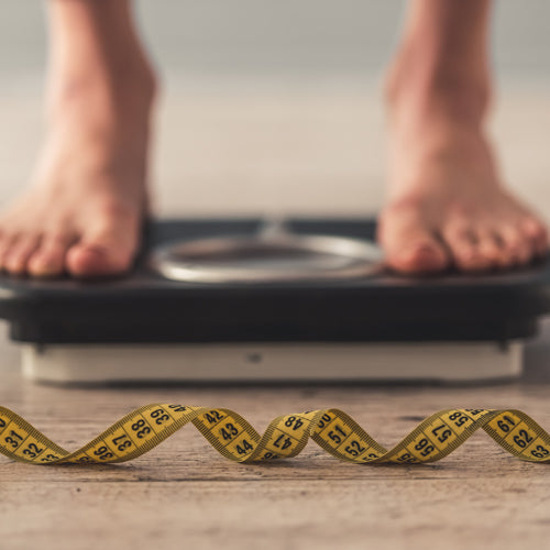 a person is standing on a weight scale