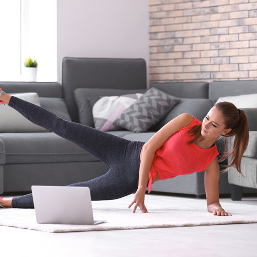 a woman is stretching in living room