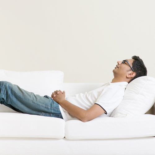 a man lying on sofa